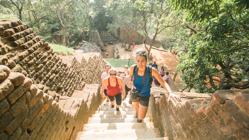 Travellers climbing steps to Sigiriya in Sri Lanka