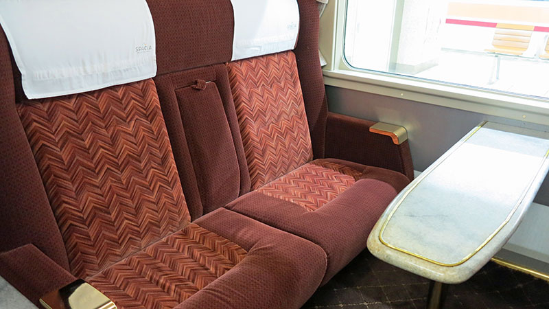 Two soft train seats with a bench in the Green Car section of Japanese trains.