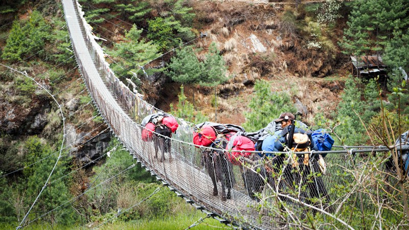 Crossing a suspension bridge in the Himalayas