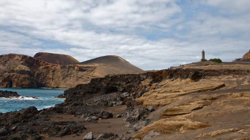 Capelinhos Faial Azores Portugal - a landscape image of volcanic terrain with black and brown land near the ocean. 