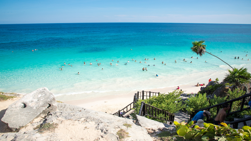 People swimming in the sea at the Tulum Ruins public beach 