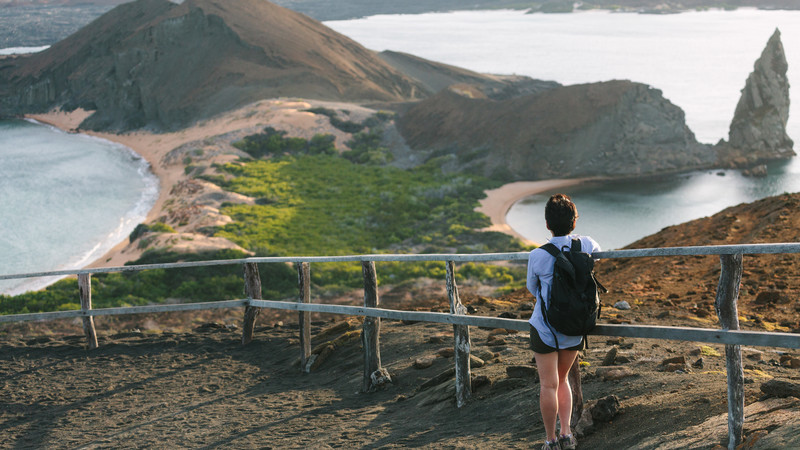 A hiker looks out over the Galapagos Islands