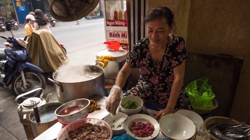 A woman sells pho in Hanoi