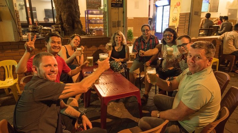A group of travellers outside a bia hoi bar