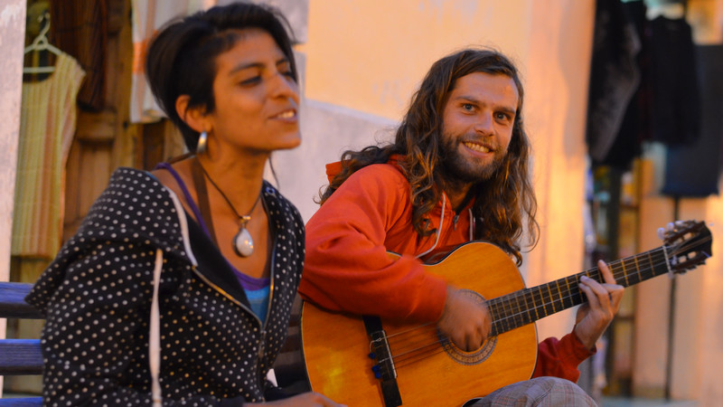 Two buskers sing and play guitar on the streets of Mexico City