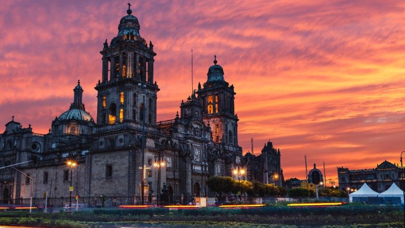The sun rises over the Mexico City Metropolitan Cathedral in the Zocalo Square in Mexico City