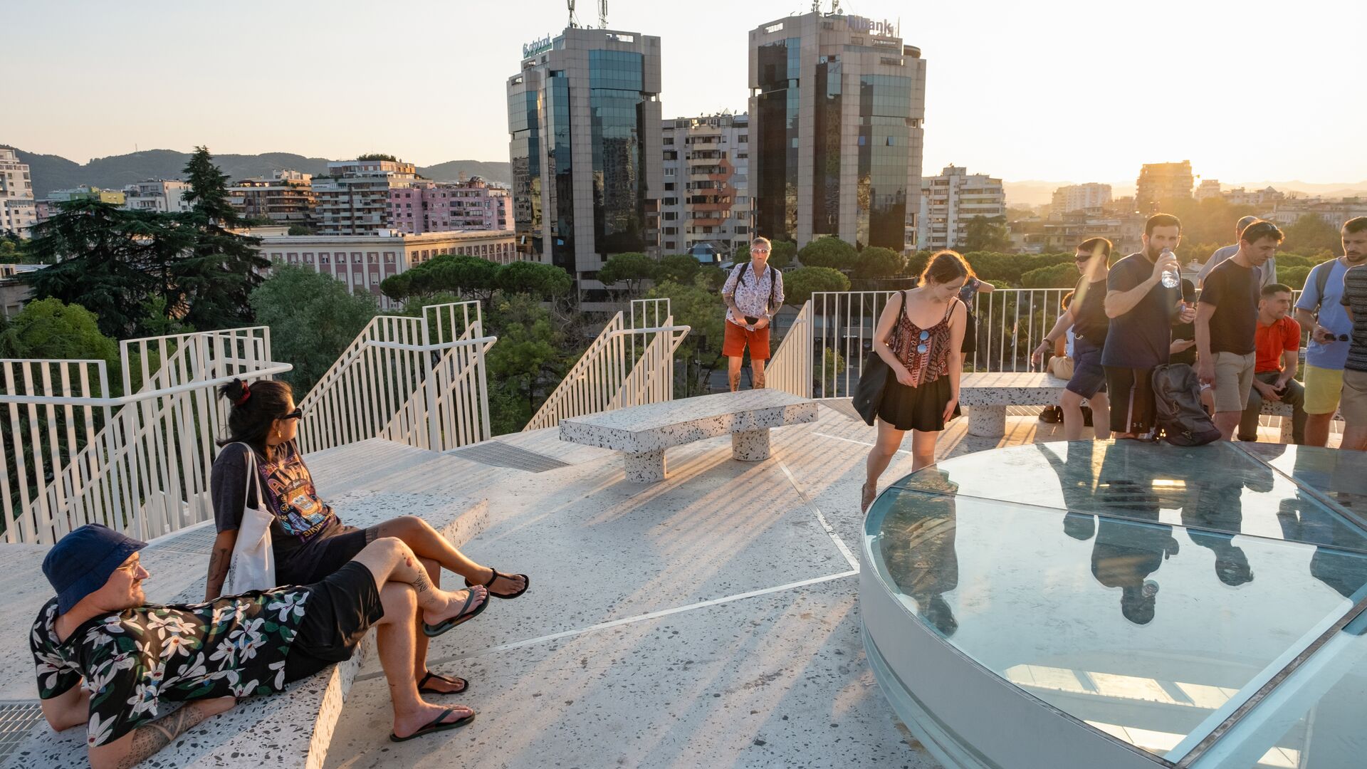 A group of travellers hanging out on the rooftop of the Pyramid of Tirana in Albania