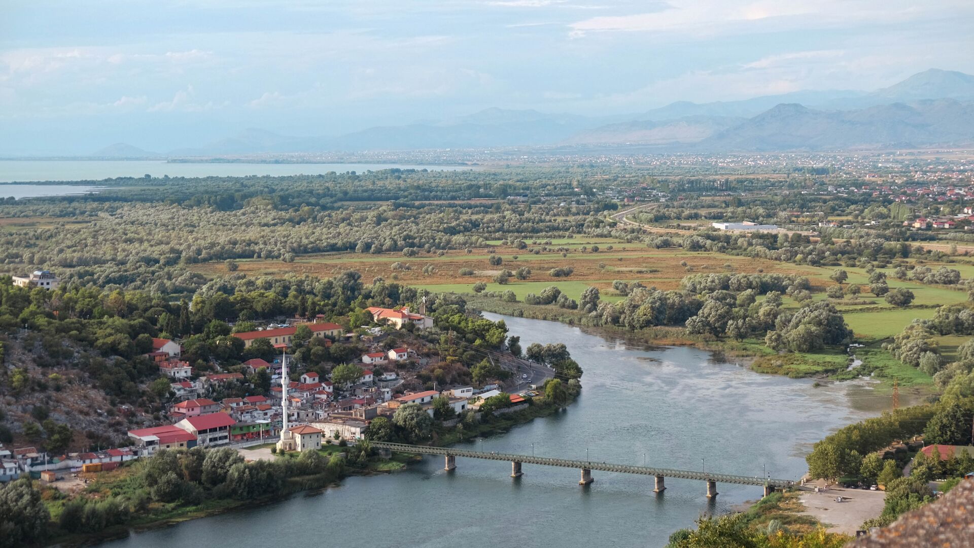 A bird's eye view of a section of river that snakes through the city of Shkoder in Albania