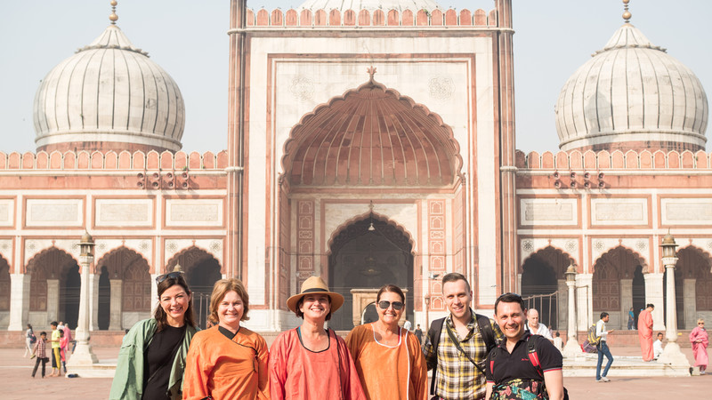 A group of travellers pose in front of the Jama Masjid in India