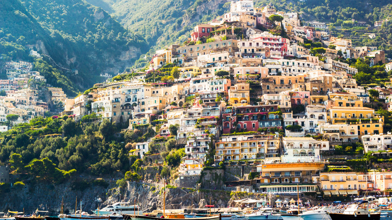 Colourful houses built into the side of a mountain in Positano