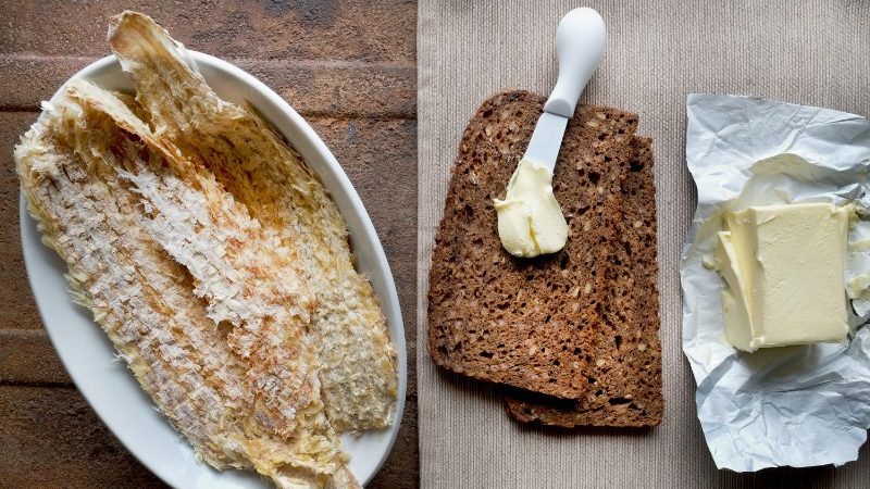 Dried fish and rye bread on a table