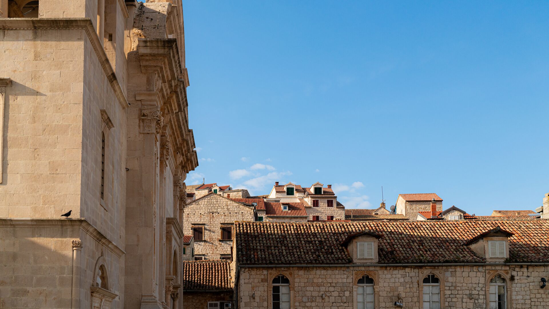 The tops of buildings and a blue sky in Hvar.
