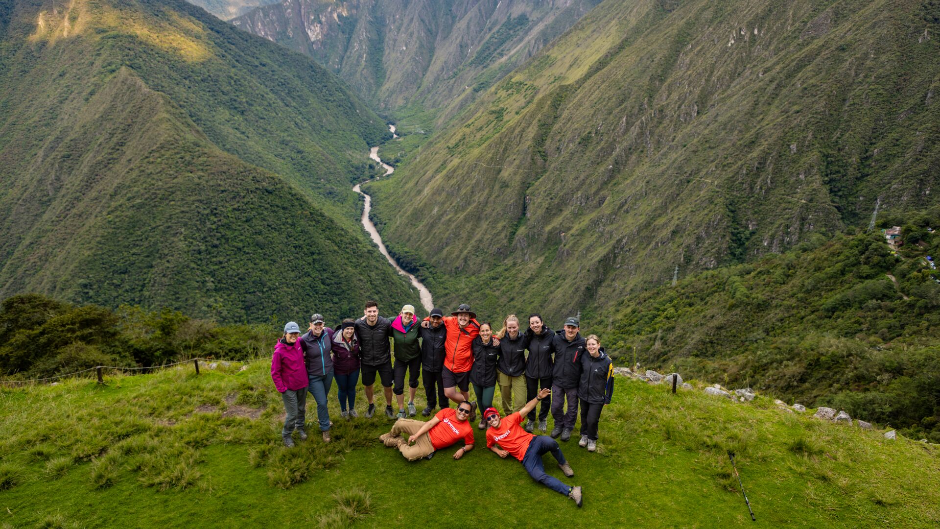 A group of Intrepid travellers posing for a photo on a mountain pass on the Inca Trail