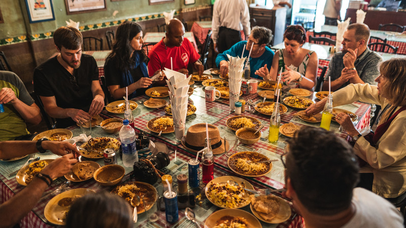 Tour group sharing meal in India. Image by Benemac.