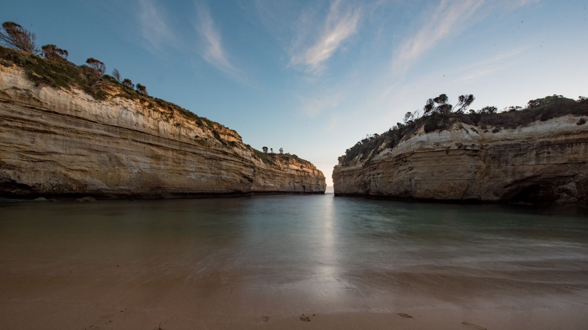 An eye level photo of the Loch Ard Gorge with receding water