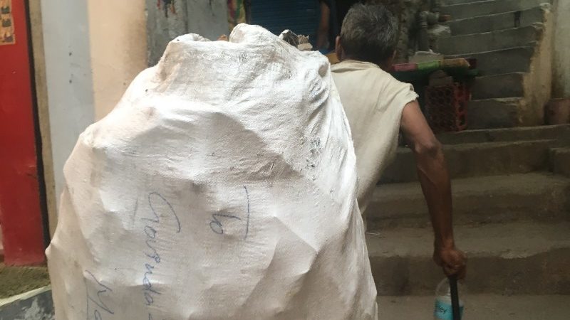 man carrying sack on his back