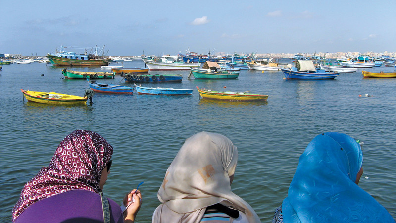 Local women looking out over the water in Alexandria, Egypt