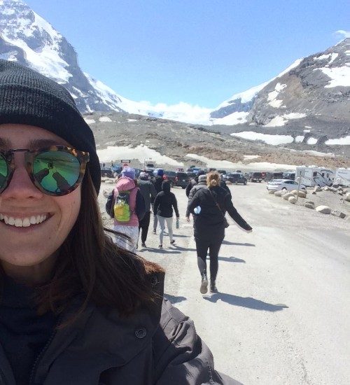 A woman takes a selfie in the rocky mountains