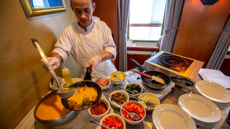A chef prepares to cook an omelette