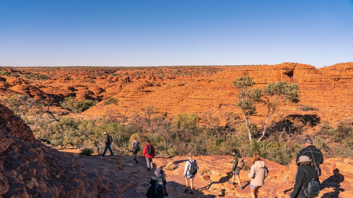 A group of hikers walk along the Kings Canyon Rim