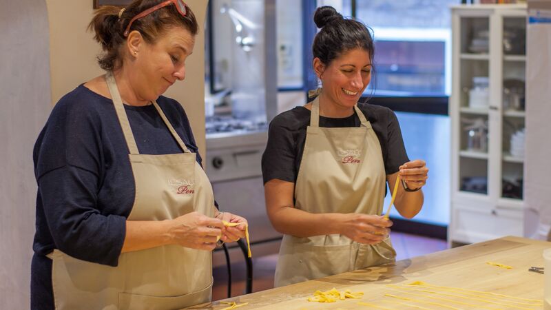 Two people making pasta in Italy