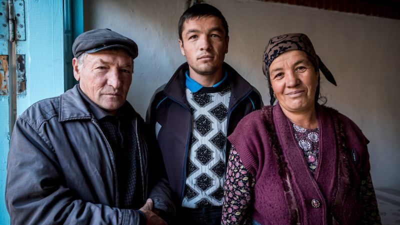 Misha, Tamara and their son Shukrat pose for a photo.