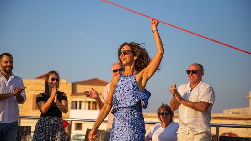 travellers dancing aboard the deck of their small ship