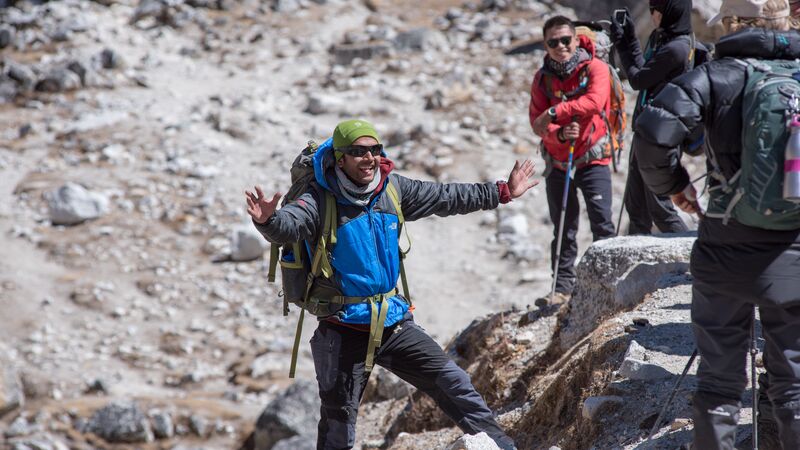 A smiling man wearing hiking gear