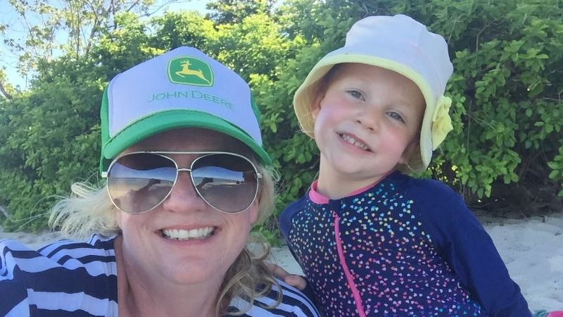 A mother with her daughter on a beach
