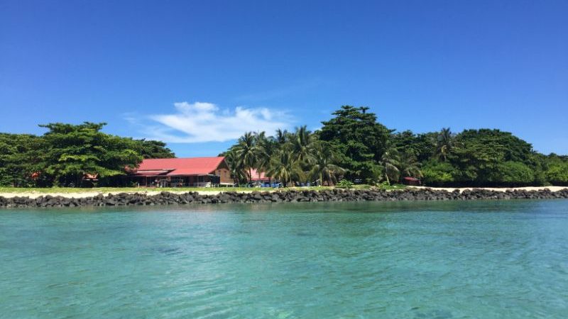 A red building on a beautiful island.