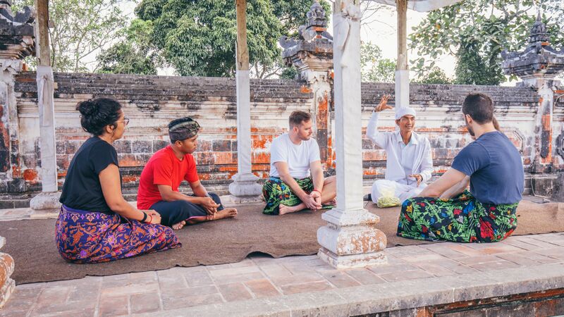 A group of travellers at a ceremony in Bali