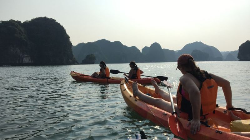 People sitting in kayaks in Halong Bay