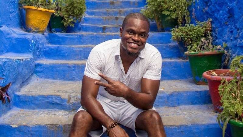 Lawrence posing for photo on blue steps