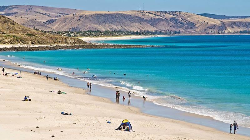 Beach-goers swimming and sunbathing on Carrickalinga Beach