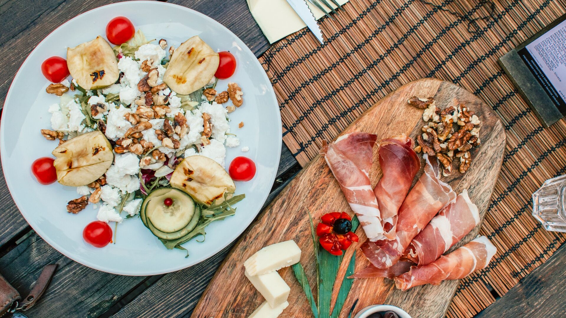 A spread of classic Slovenian appetiser dishes, including cold cuts and cheese.