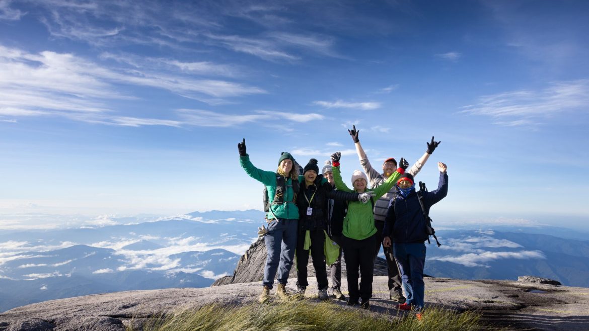 A group of Intrepid travellers standing on Low's Peak, Mt Kinabalu