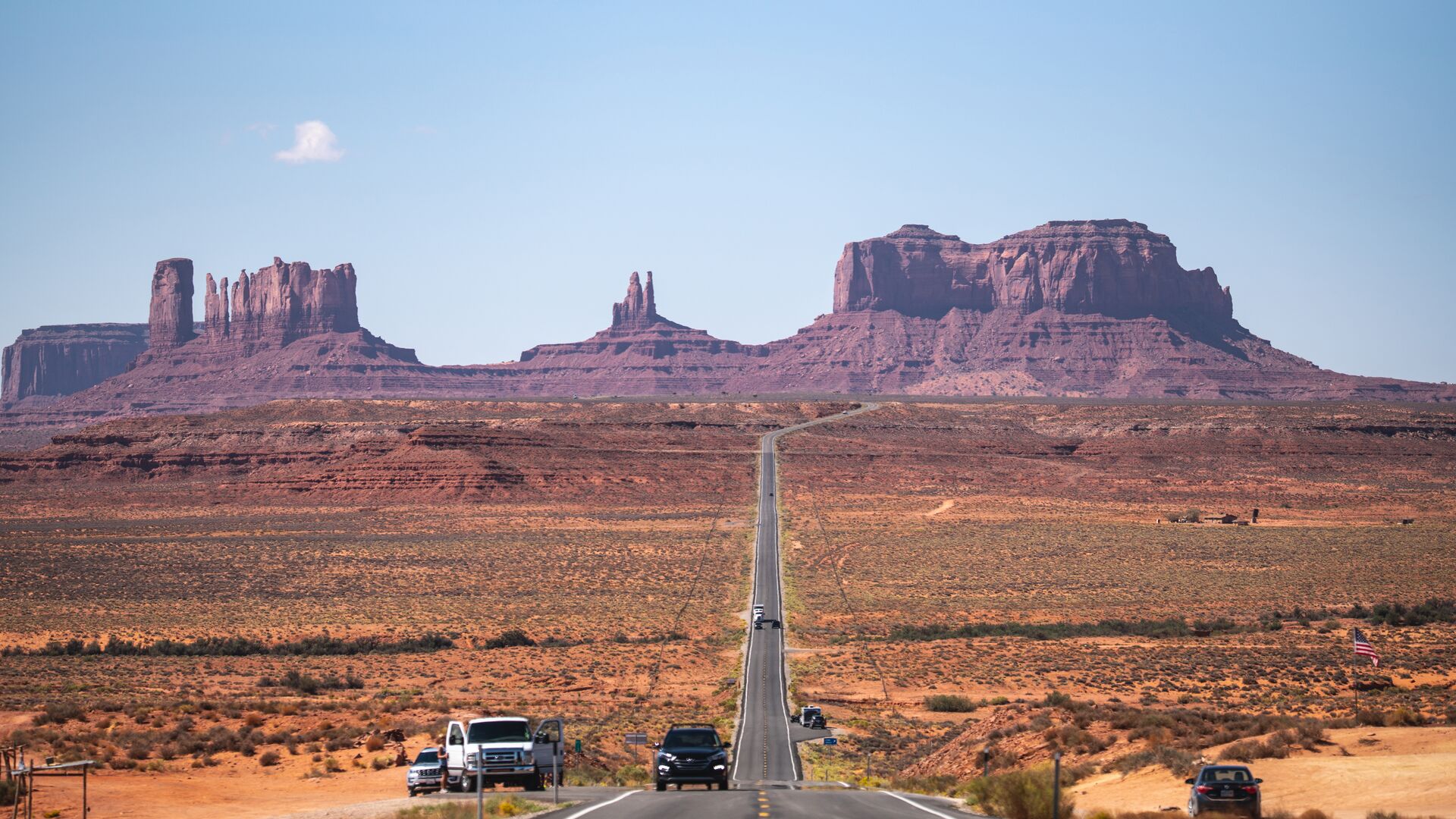 Cars driving on a road leading to Monument Valley in Arizona
