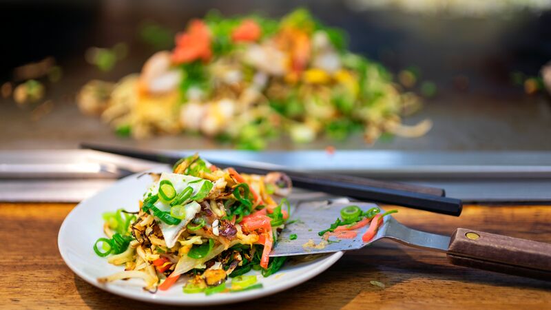 A freshly made meal with vegetables and spring onions.
