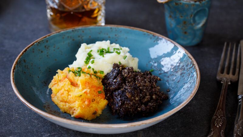 A plate of haggis with mashed potato.