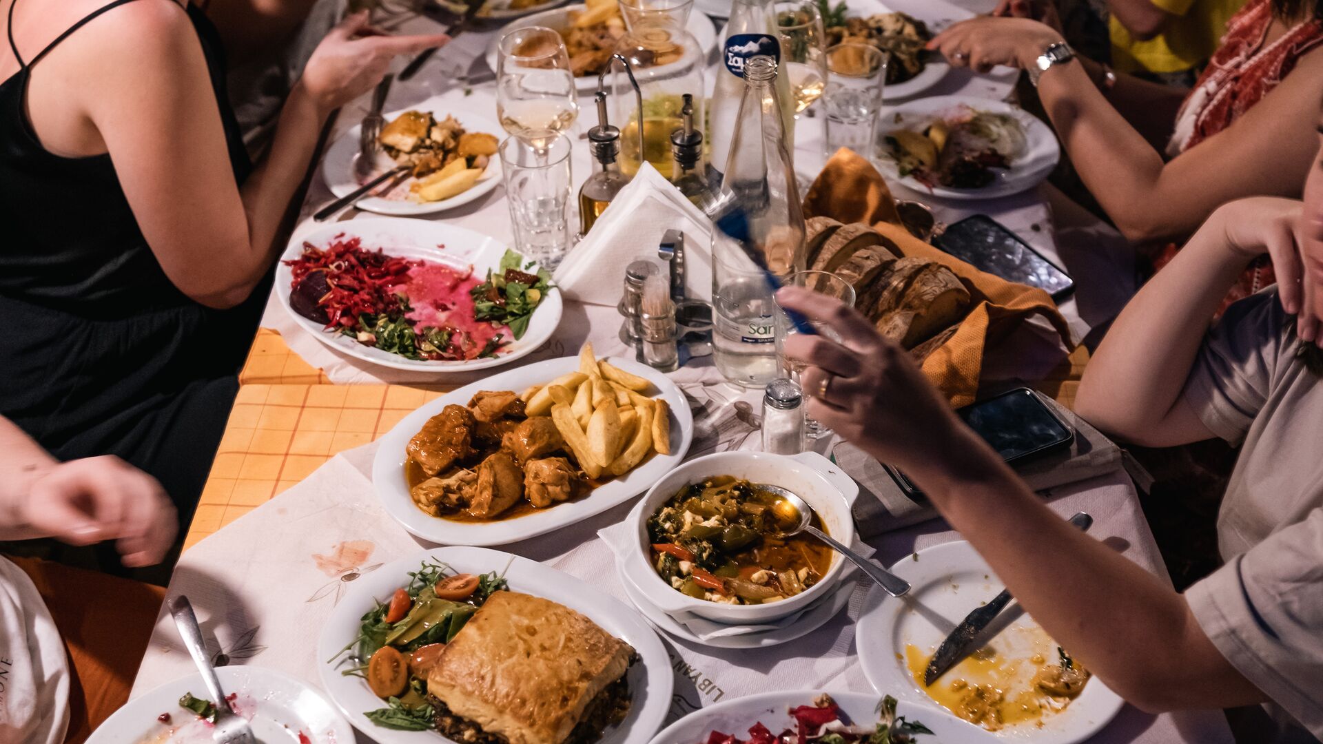 Travellers tucking into a spread of traditional Greek food in Crete