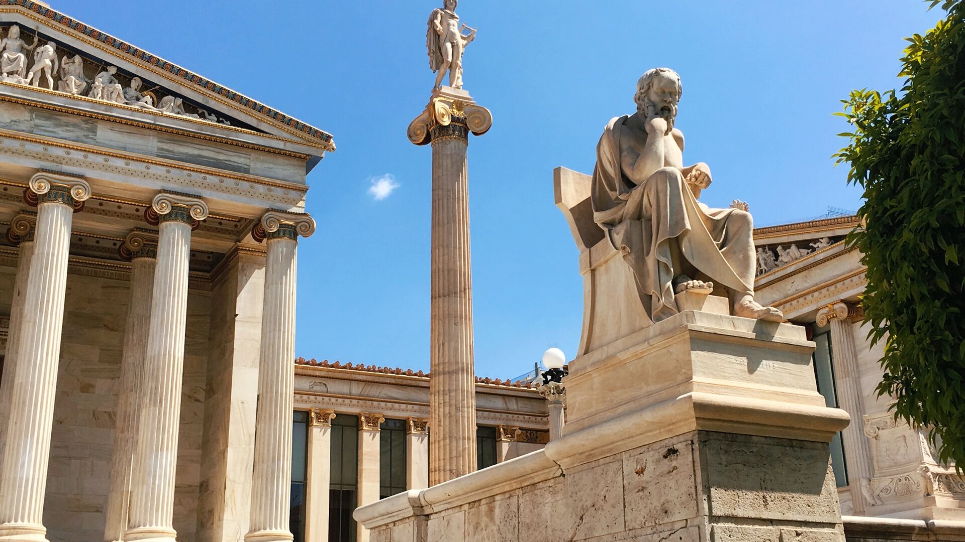 Pillared buildings and a statue outside the the Academy of Athens