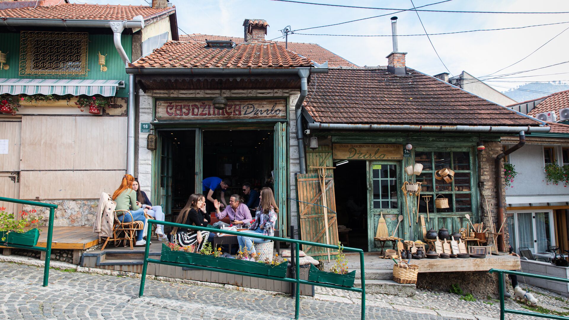People sit outside chatting in a cafe in Sarajevo