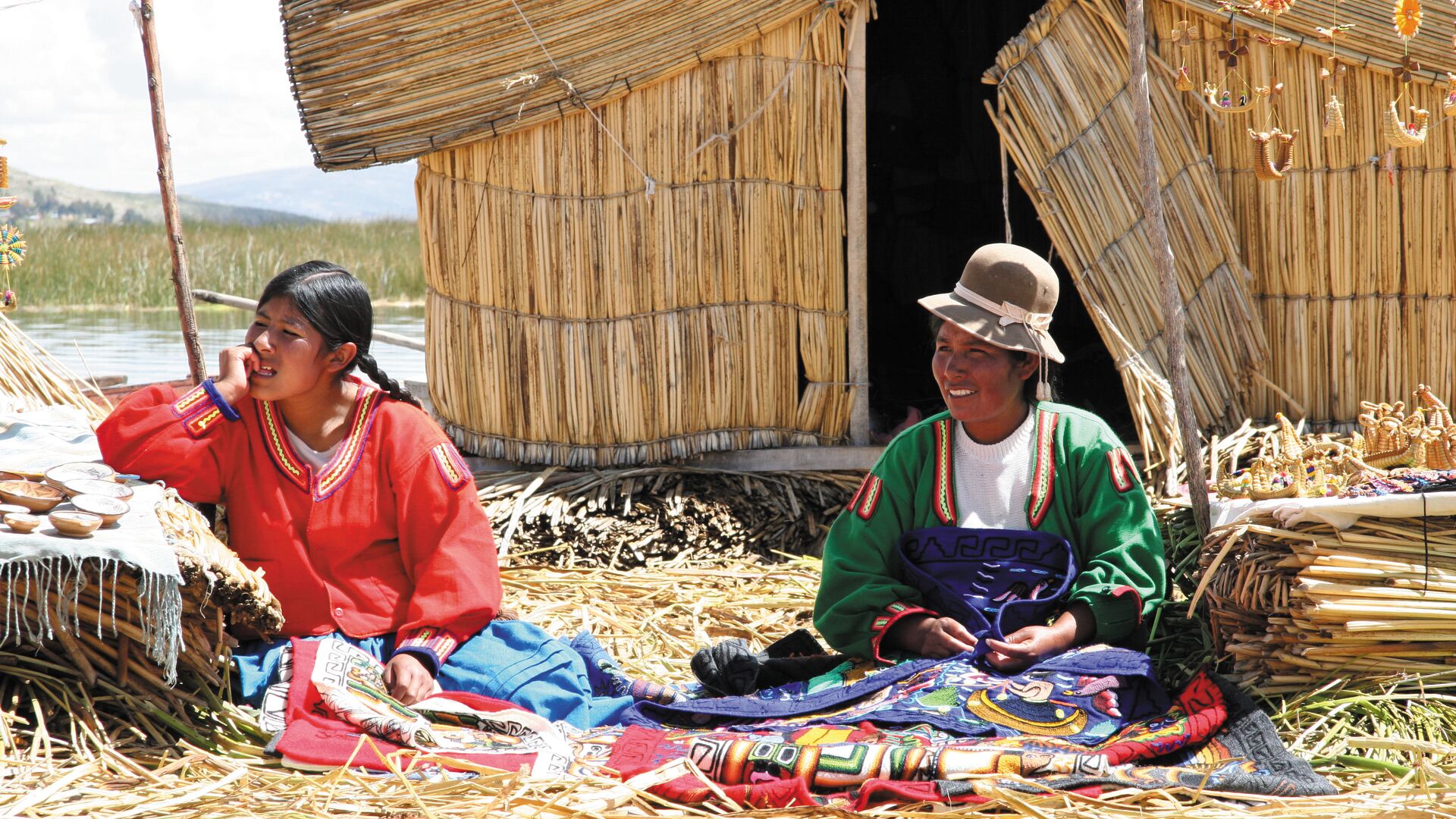 Uros women handcrafting colourful textiles with intricate embroidery designs on Lake Titicaca