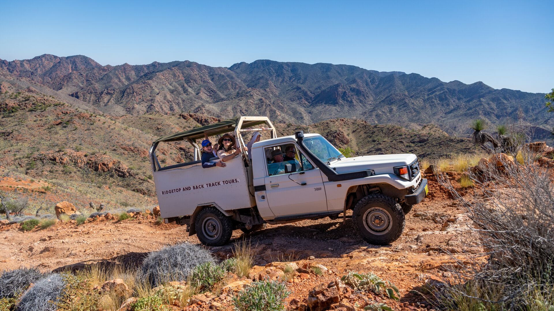 A 4WD moves through the bushland of Arkaroola Village in South Australia.