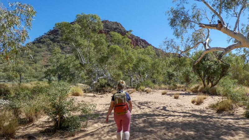 A hiker walking a sandy section of the Larapinta Trail in the Northern Territory, Australia