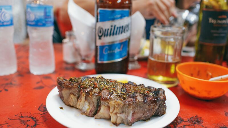 A big, juicy and well seasoned steak on a plate at a restaurant in Argentina.