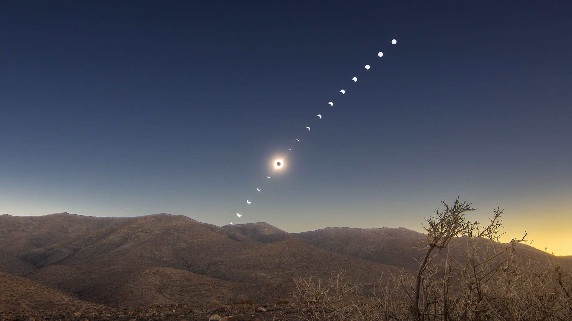 a solar eclipse sequence above a desert sky
