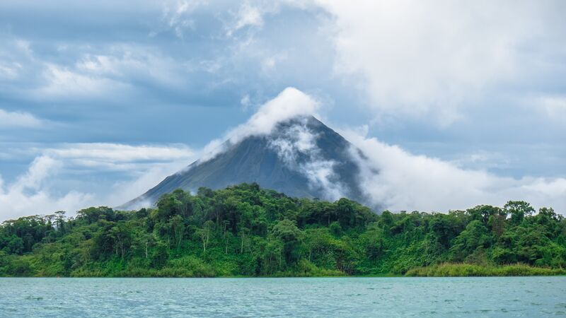 Costa Rica's Arenal Volcano shrouded in a gray mist.