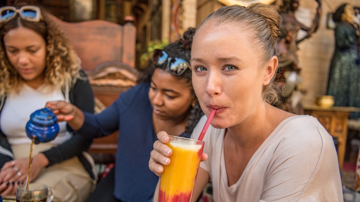 a woman drinking a cocktail