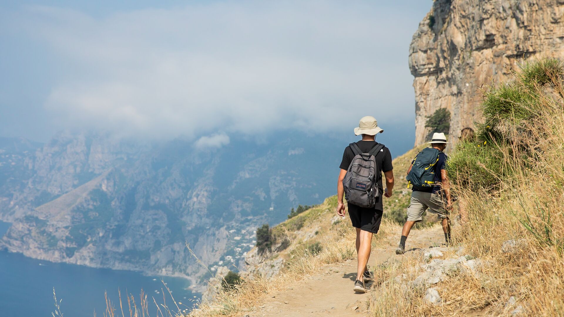 Two hikers on the Path of the Gods trail on the Amalfi Coast